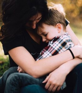 Woman holding little boy on her lap