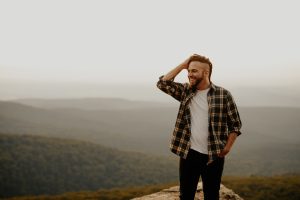 man stood happy and smiling in nature